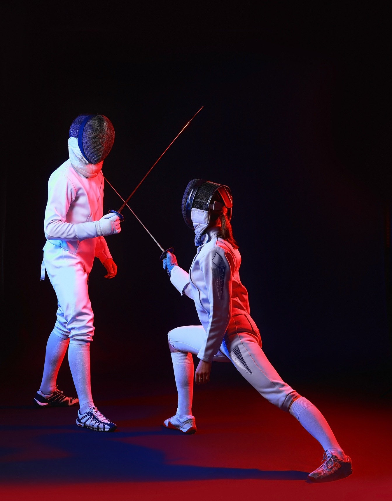 Toned Photo of Fencers on Dark Background